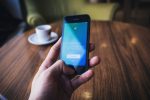 In an article about voice tweets and the Deaf community, a hand holding a phone with Twitter on it